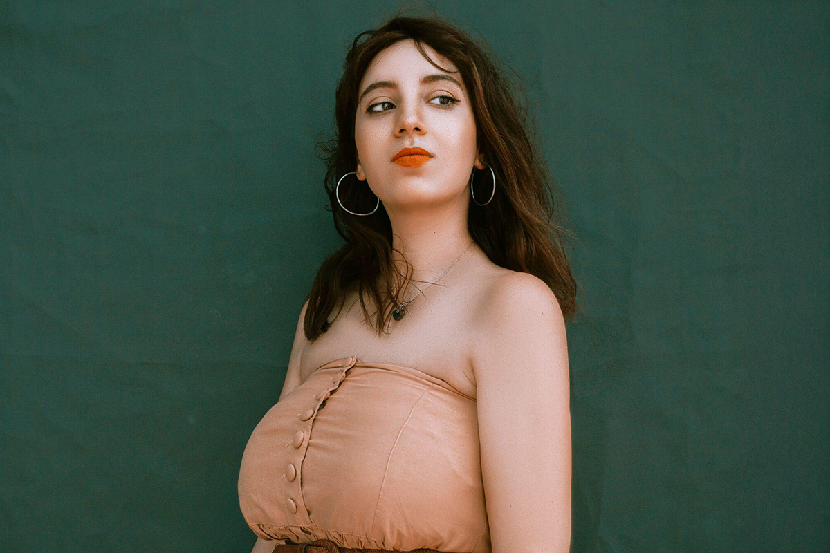 Woman standing confidently in strapless dress, representing outcomes of breast reduction surgery and improved posture.