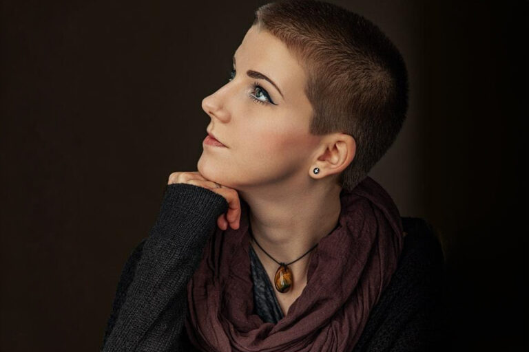 Profile of a thoughtful woman looking upward, symbolizing recovery and confidence after nose surgery