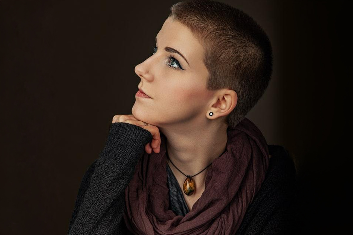 Profile of a thoughtful woman looking upward, symbolizing recovery and confidence after nose surgery