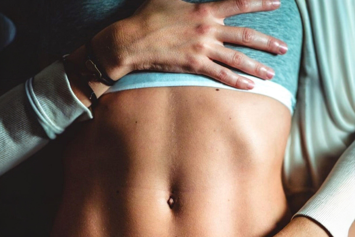 Close-up of toned abdomen showing potential liposuction area for fat reduction