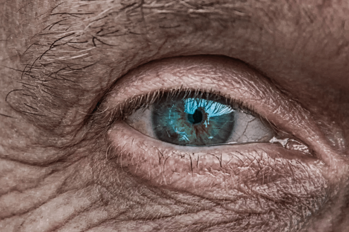 Close-up of an aging blue eye with visible wrinkles, symbolizing the impact of untreated cataracts on vision over time
