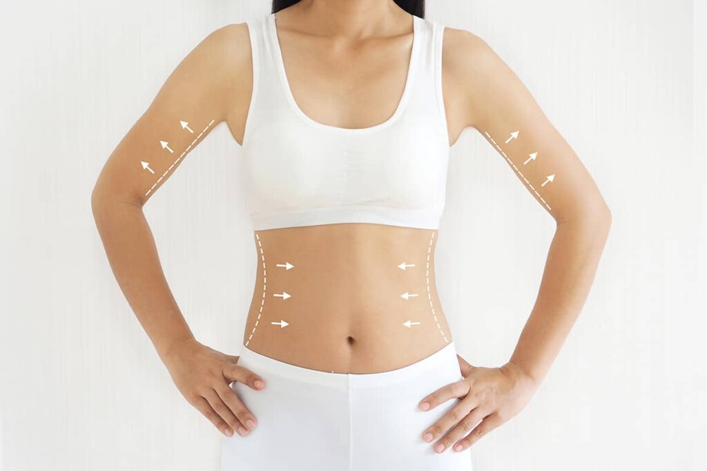 Front view of a woman in a white sports bra and shorts with overlay graphics showing white dotted lines and upward arrows on her arms and torso.